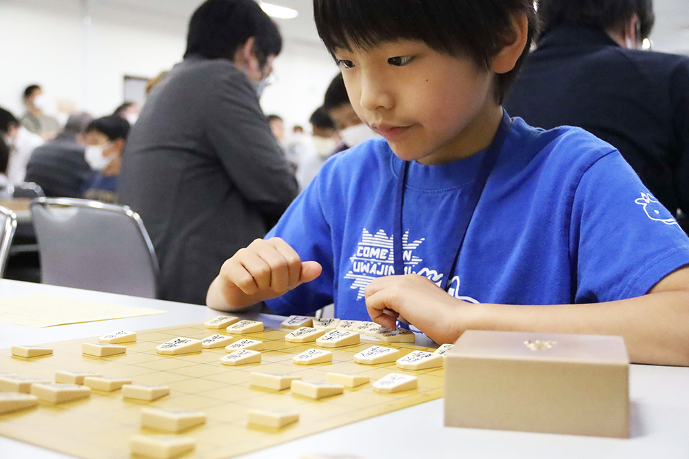 真剣な表情で盤面を見る子ども