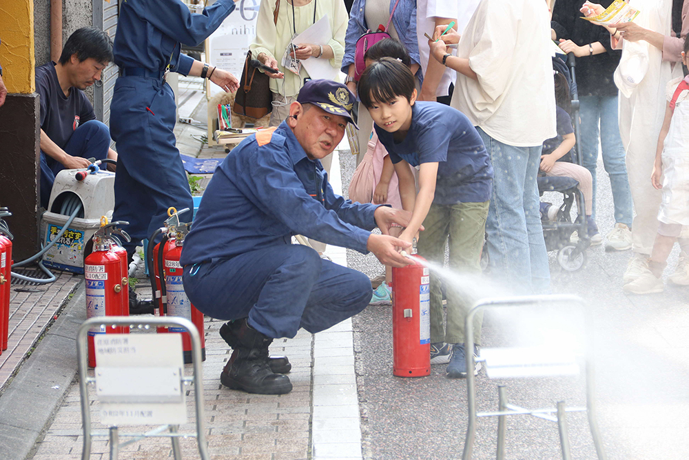 水消火器体験をする子どもの画像