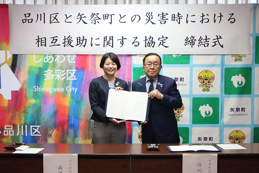 協定書を持って写真を撮る森澤区長と佐川町長の画像
