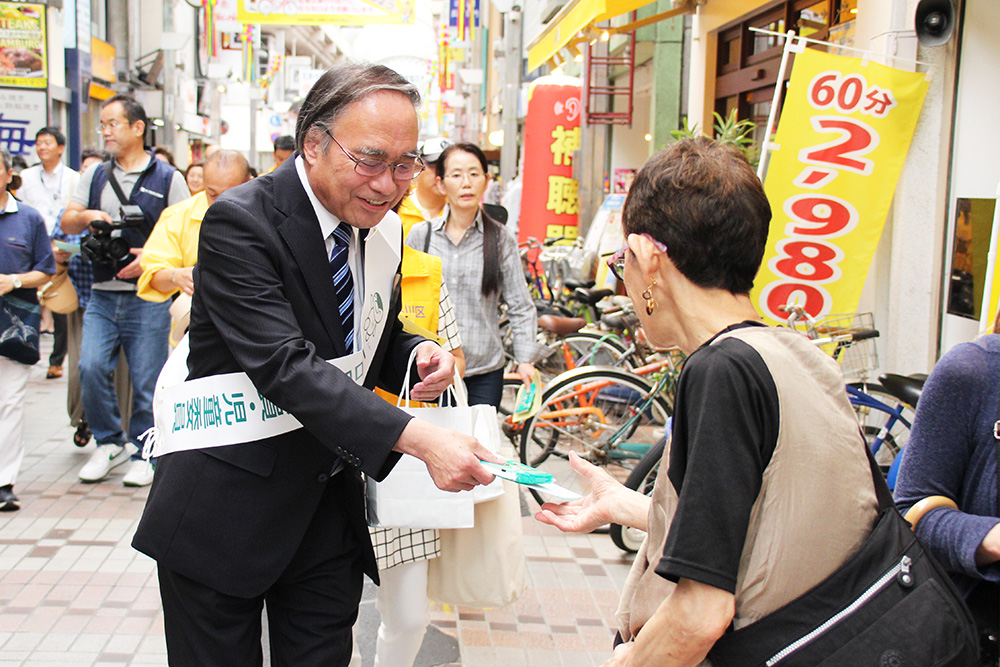 商店街で啓発活動する濱野区長