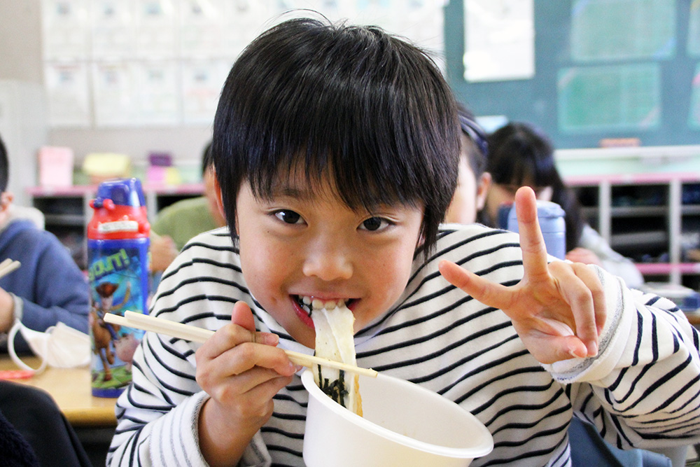 お餅を食べてピースサイン