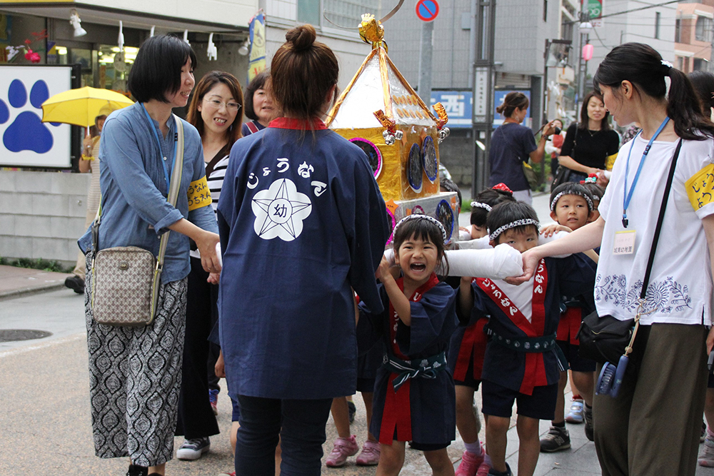 幼稚園児も一生懸命に神輿を担ぐ