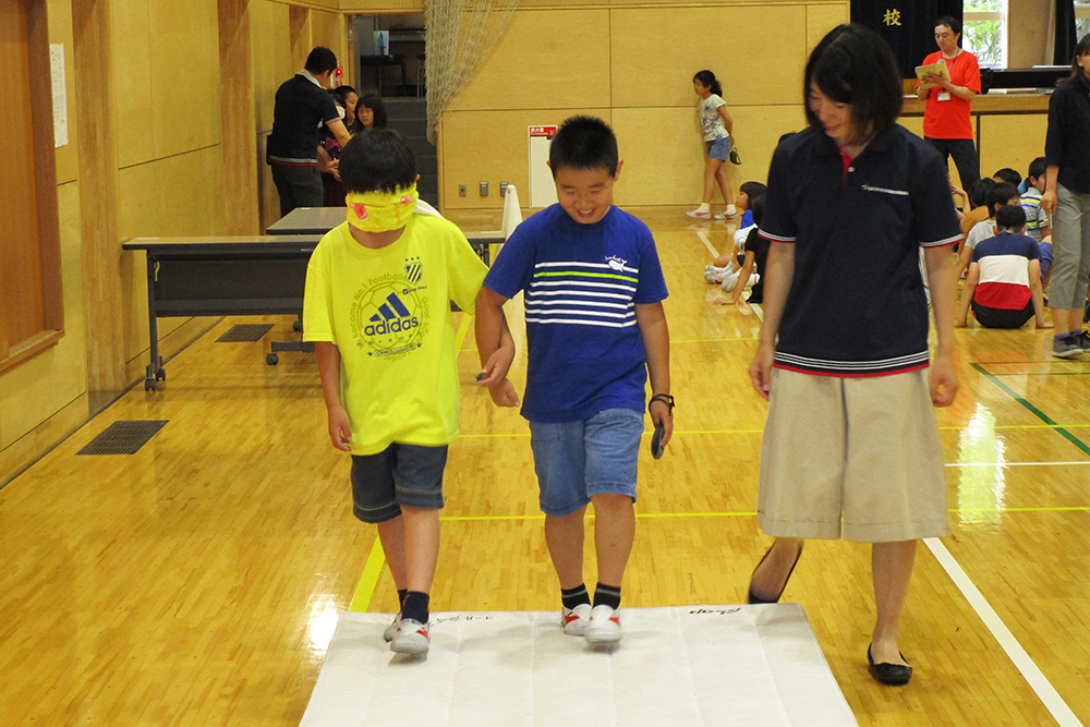 アイマスクをした児童に、段差を伝える