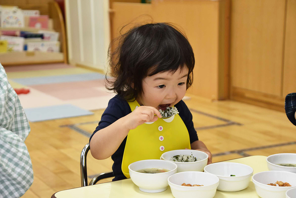 アルファ化米を使ったわかめご飯を食べる園児