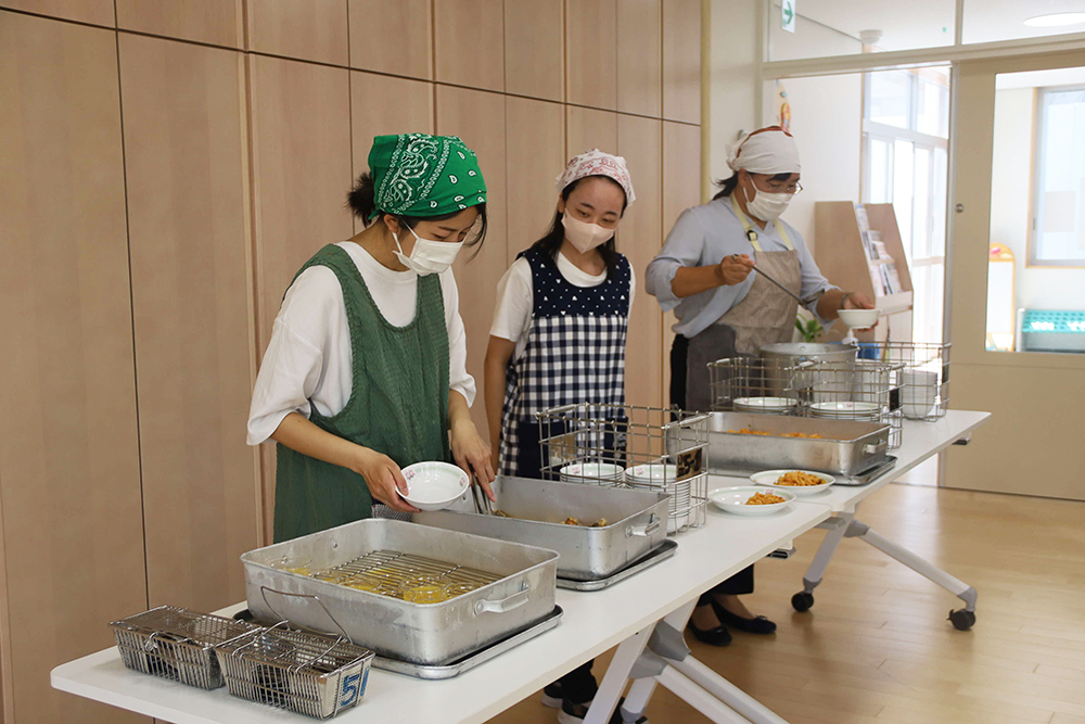 給食を盛り付ける先生たち