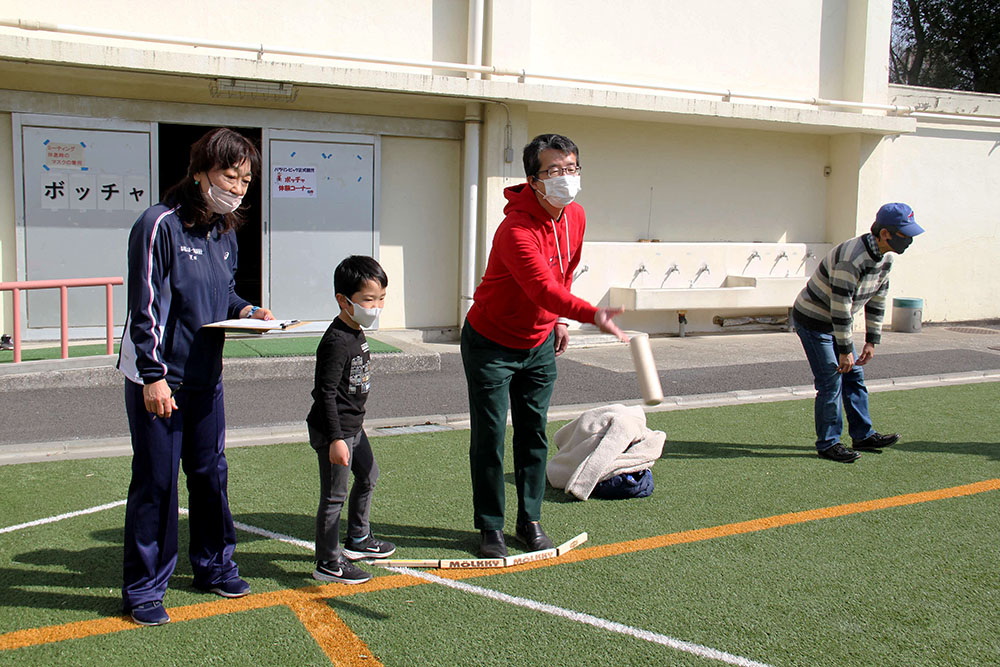 モルックを投げる父を見つめる子ども