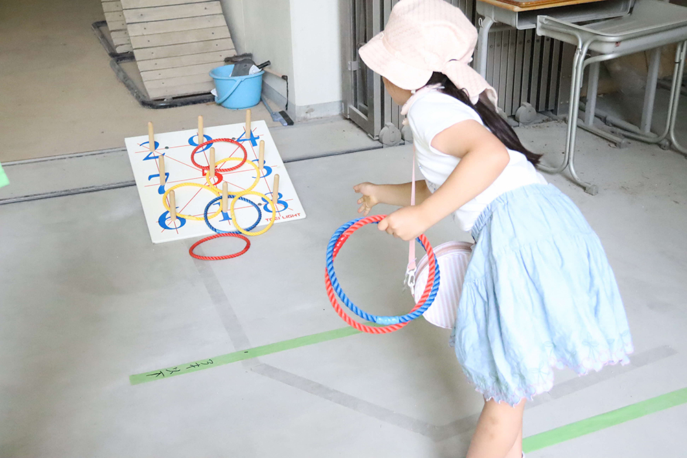 輪投げを体験する子どもの画像