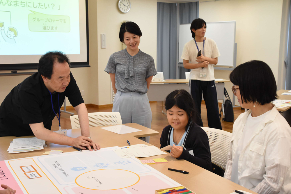 話し合っているところを眺めている区長の写真