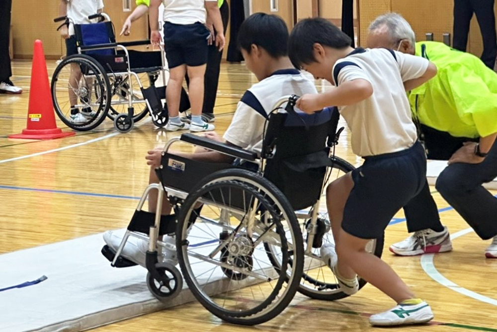 子どもたちが車椅子の体験をしている様子の写真