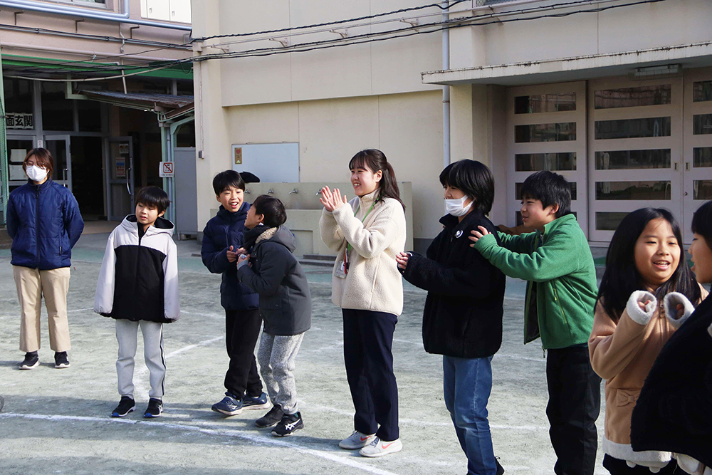 応援する児童と先生の画像