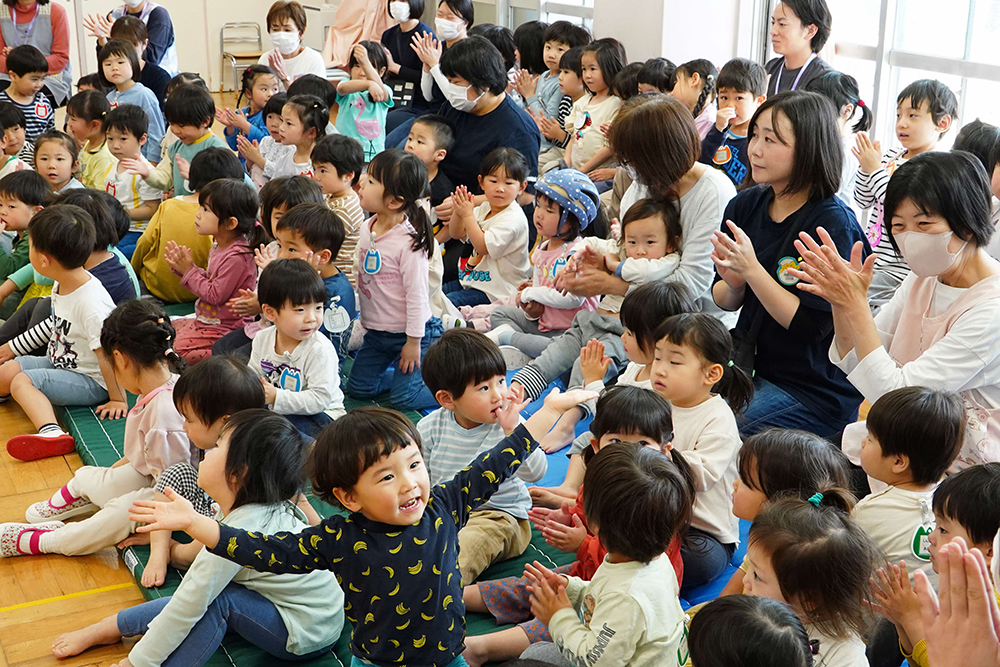 拍手をしている保護者たちの写真