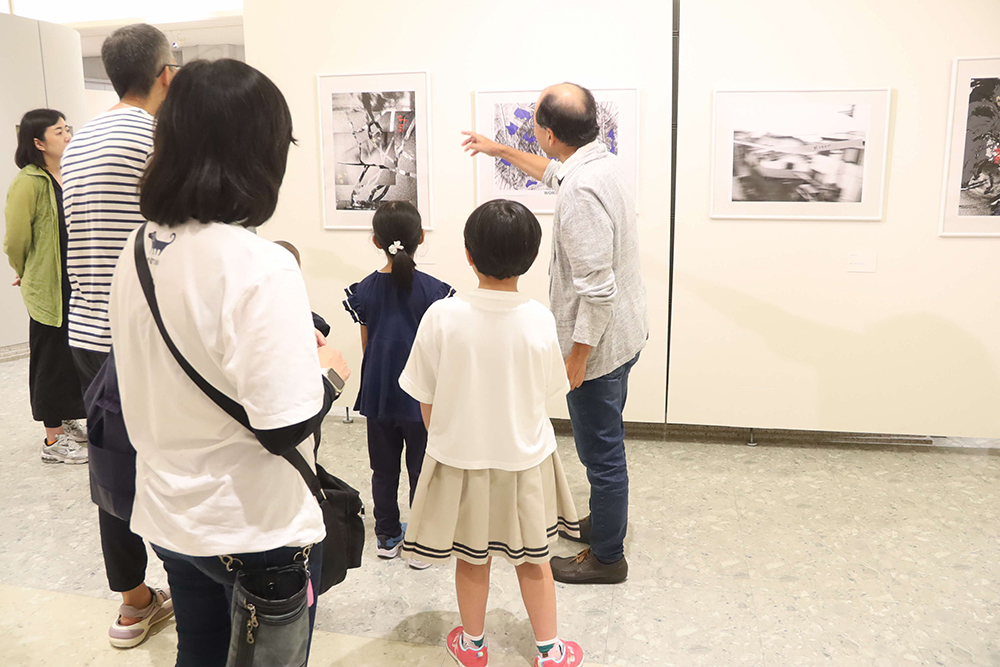 作品について説明する講師とワークショップ参加者の画像