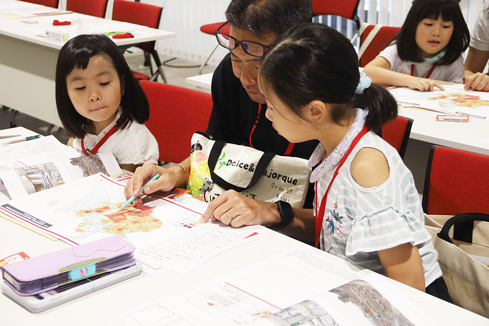 防災ノートに記入する親子の画像
