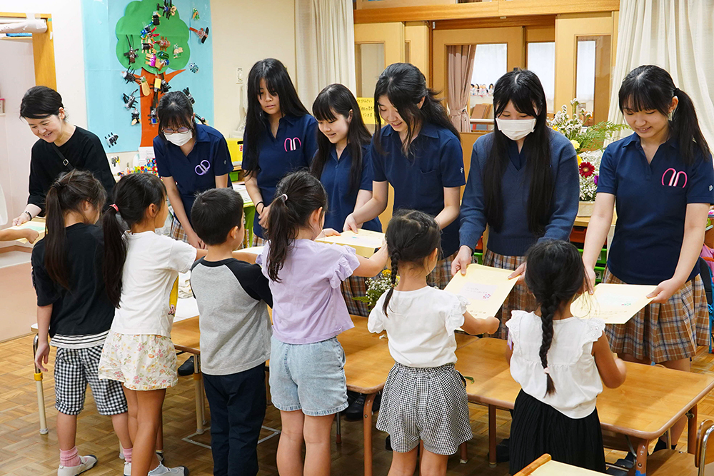 園児たちが品川女子学院の生徒にお礼と手紙を渡している写真