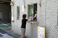 駐車場管理室でバッテリーの受け渡し