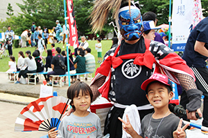 伝統芸能の鬼剣舞の踊り手と記念撮影をする子どもたち