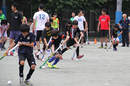 ドリブルでボールを運ぶ少年たち