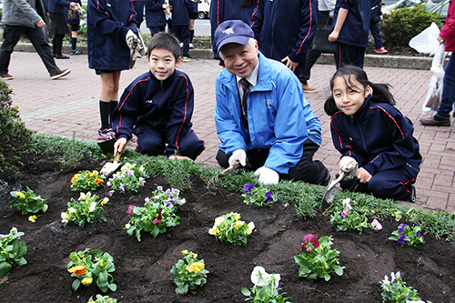 植え替えを終えて伊与田会長と日野学園児童