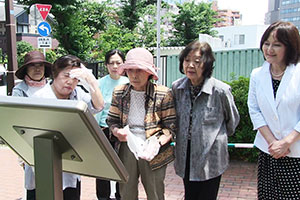 しながわ平和の花壇のプレートを見る町会の方々