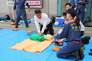 消防署職員の指導を受けてAED訓練
